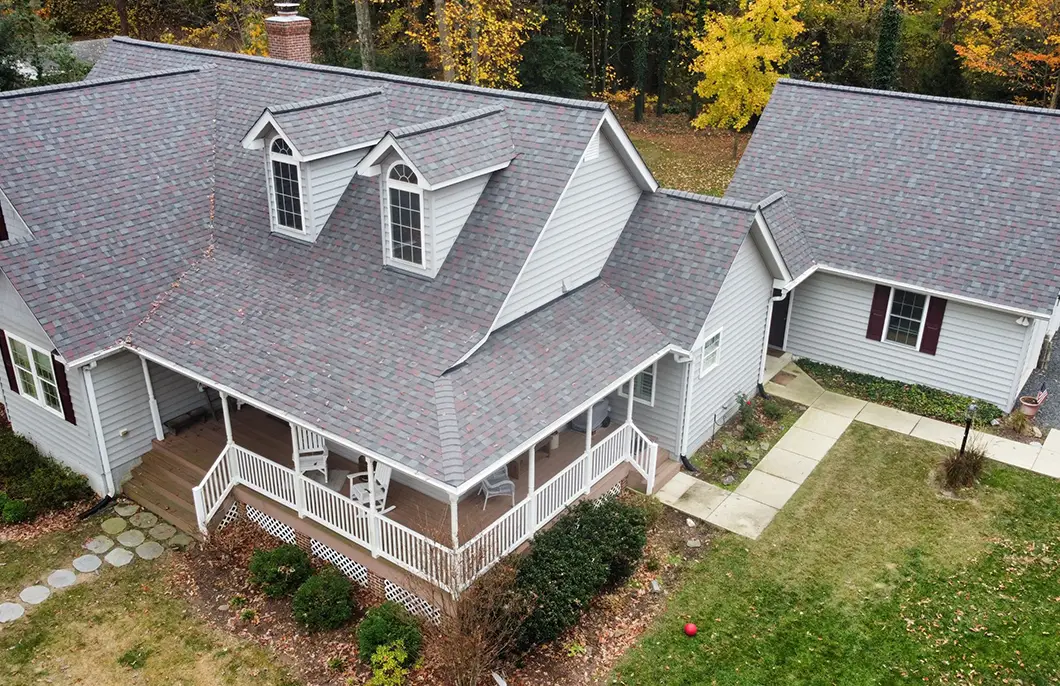 Lusby MD Roofing Contractor: Calvert Cliffs, Cove Point & Chesapeake Ranch Estates | JDH Remodeling JDH Remodeling newly installed Owens Corning Duration Colonial Slate asphalt shingle roof on a two-story Lusby Maryland home with dormers and wrap-around porch