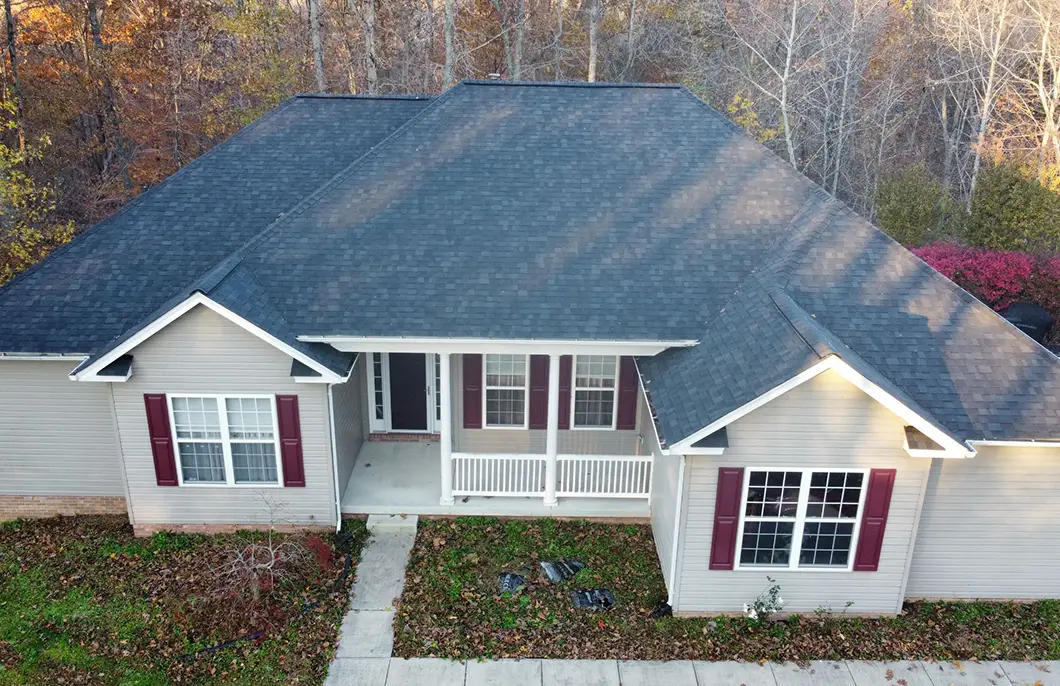 Aerial drone view of a Hughesville Maryland residential home with Owens Corning Duration Estate Gray asphalt shingle roof in the rural horse-country setting documented by JDH Remodeling