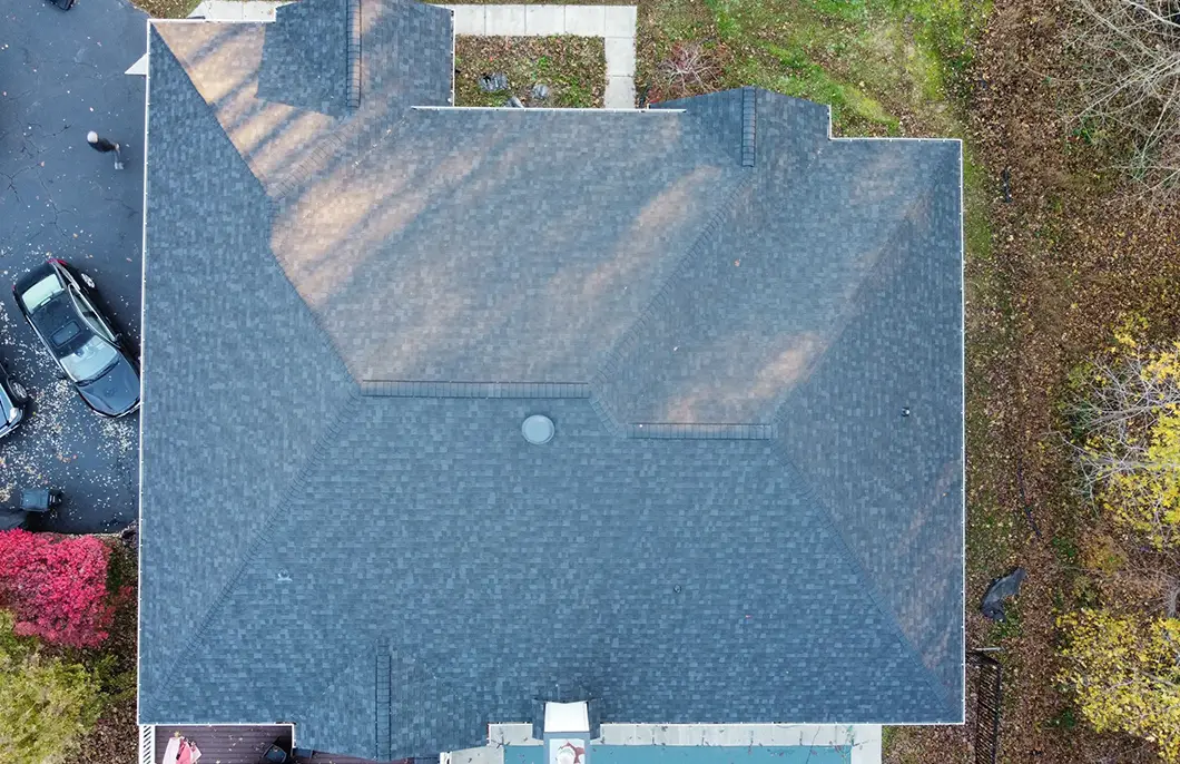 JDH Remodeling aerial completed Owens Corning Duration Estate Gray asphalt shingle install on a Hughesville Maryland home with seamless gutters and mature landscaping