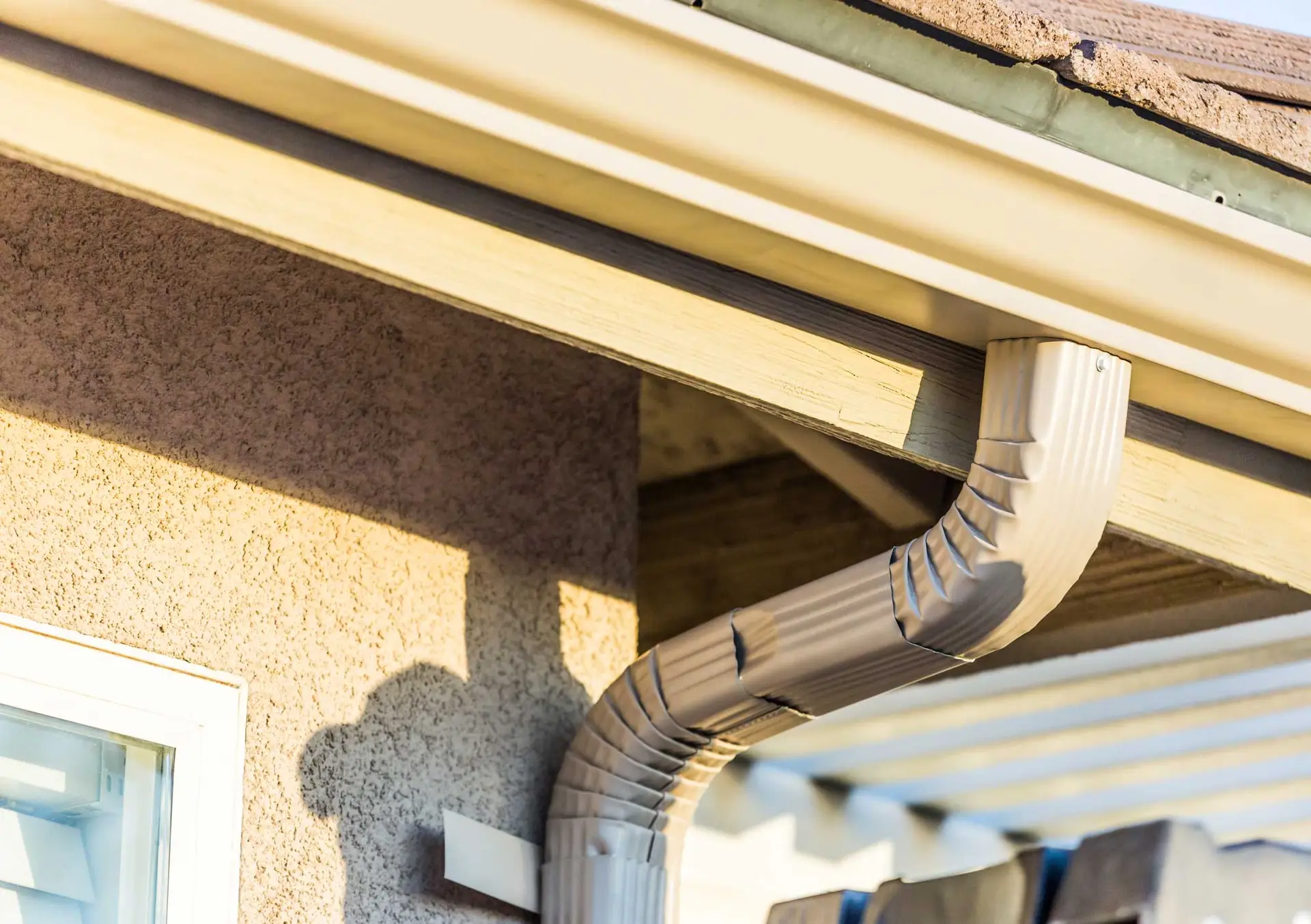 New seamless gutter and downspout installation on brick Maryland home by JDH Remodeling