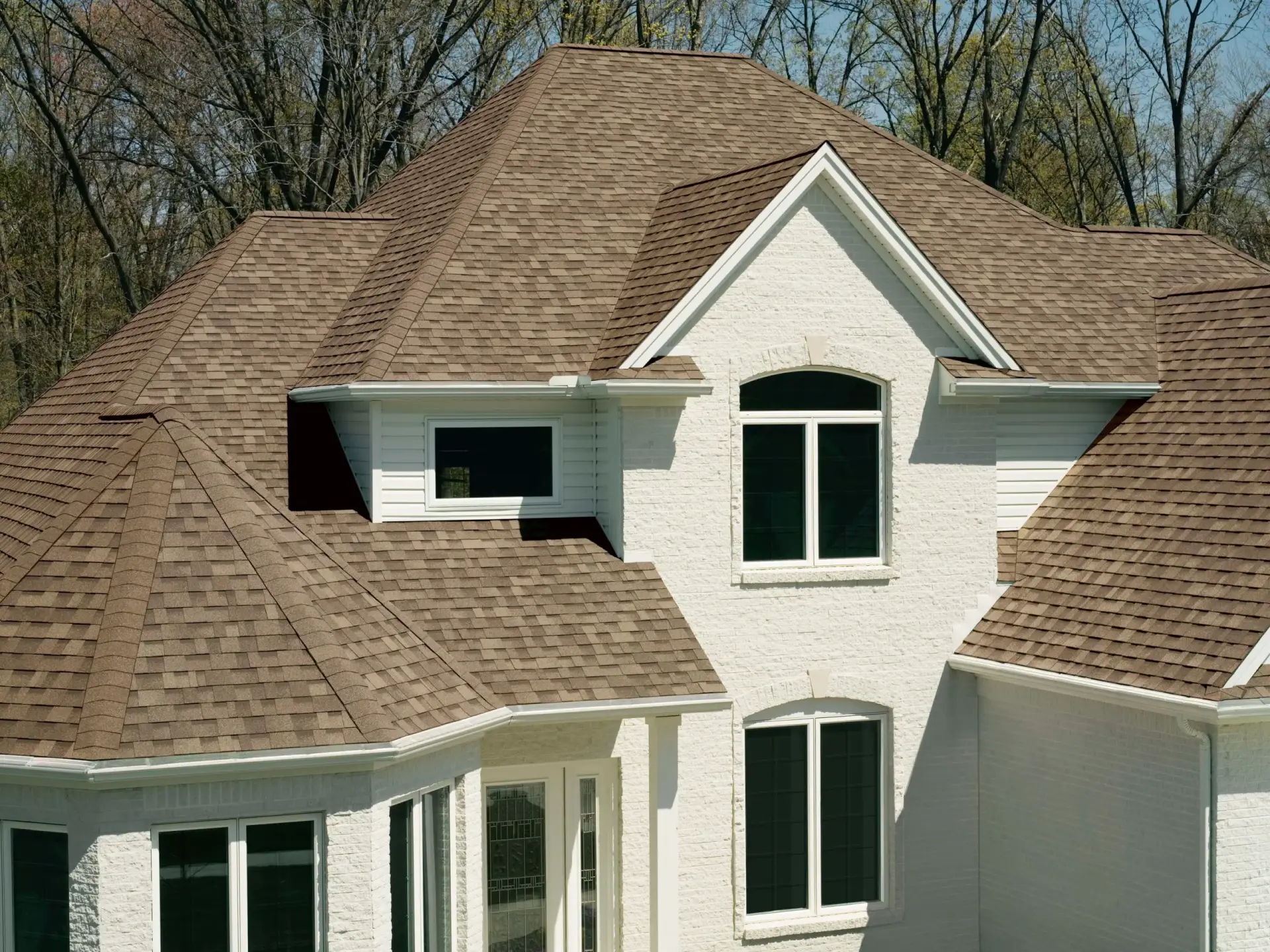 JDH Remodeling completed Owens Corning Duration Sandcastle asphalt shingle roof replacement on a multi-pitch white-brick Mechanicsville Maryland home in the Chopticon catchment