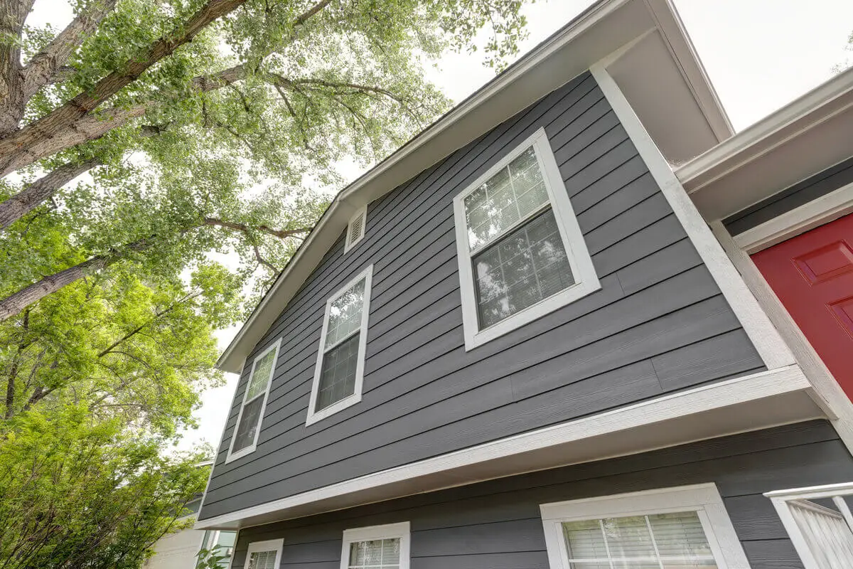 Modern home exterior with new dark gray James Hardie fiber cement siding installed by JDH Remodeling