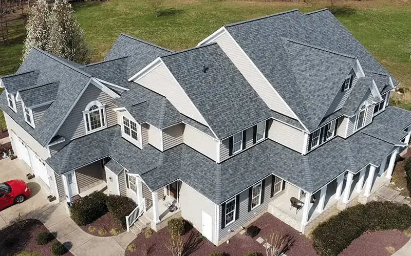 JDH Remodeling aerial completed asphalt shingle roof installation on a two-story Chesapeake Beach Maryland home with gray Owens Corning Duration shingles and white trim