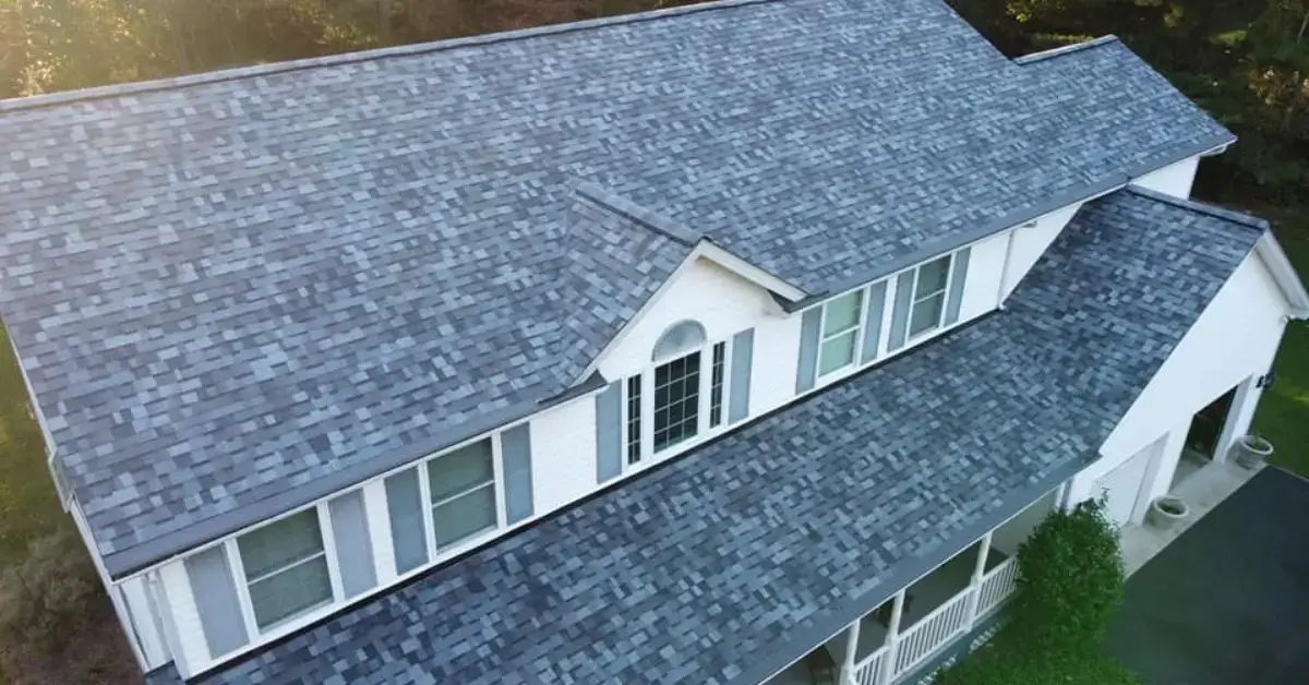 Aerial view of a completed residential roof installation with dark architectural shingles on a multi-pitched Lusby Maryland home by JDH Remodeling