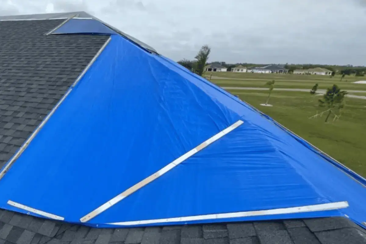 Emergency roof tarp installation after storm damage to prevent water leaks