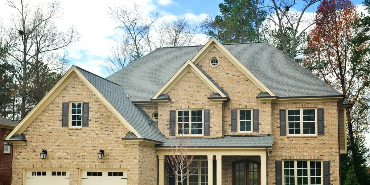 JDH Remodeling seamless K-style gutter installation on a Lexington Park Maryland two-story brick home with new roofing, windows, and siding