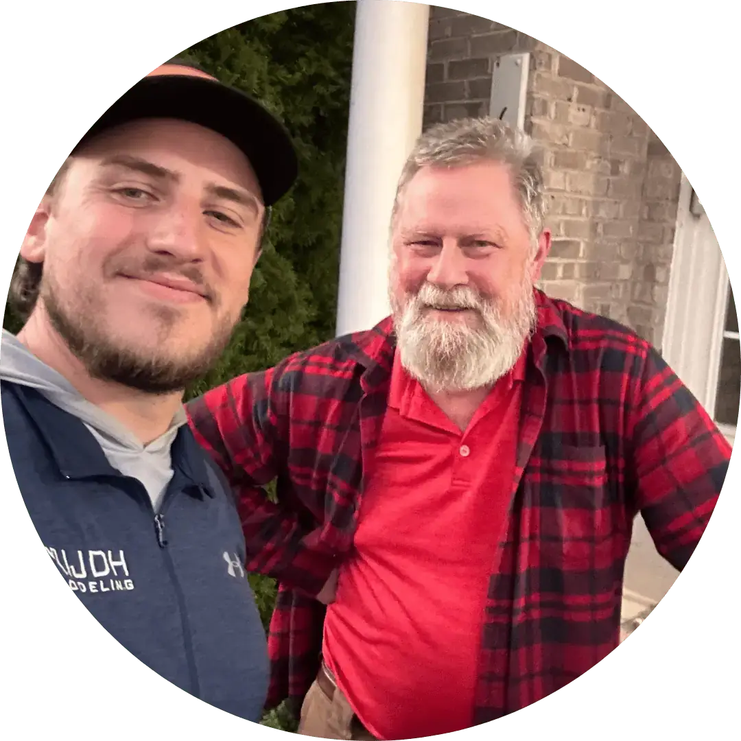 JDH Remodeling Mechanicsville Maryland customer experience photo with two contractors outside a brick home representing real Mechanicsville customer trust