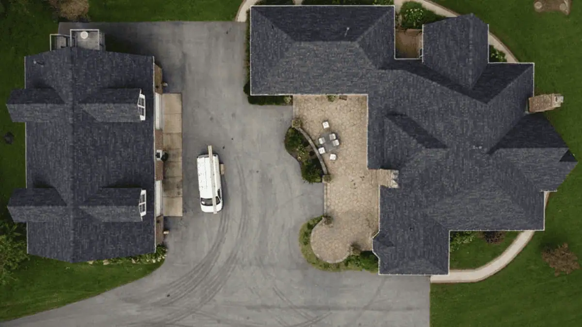 JDH Remodeling aerial overhead of two Huntingtown Maryland homes with dark asphalt shingle roofs and manicured landscaping