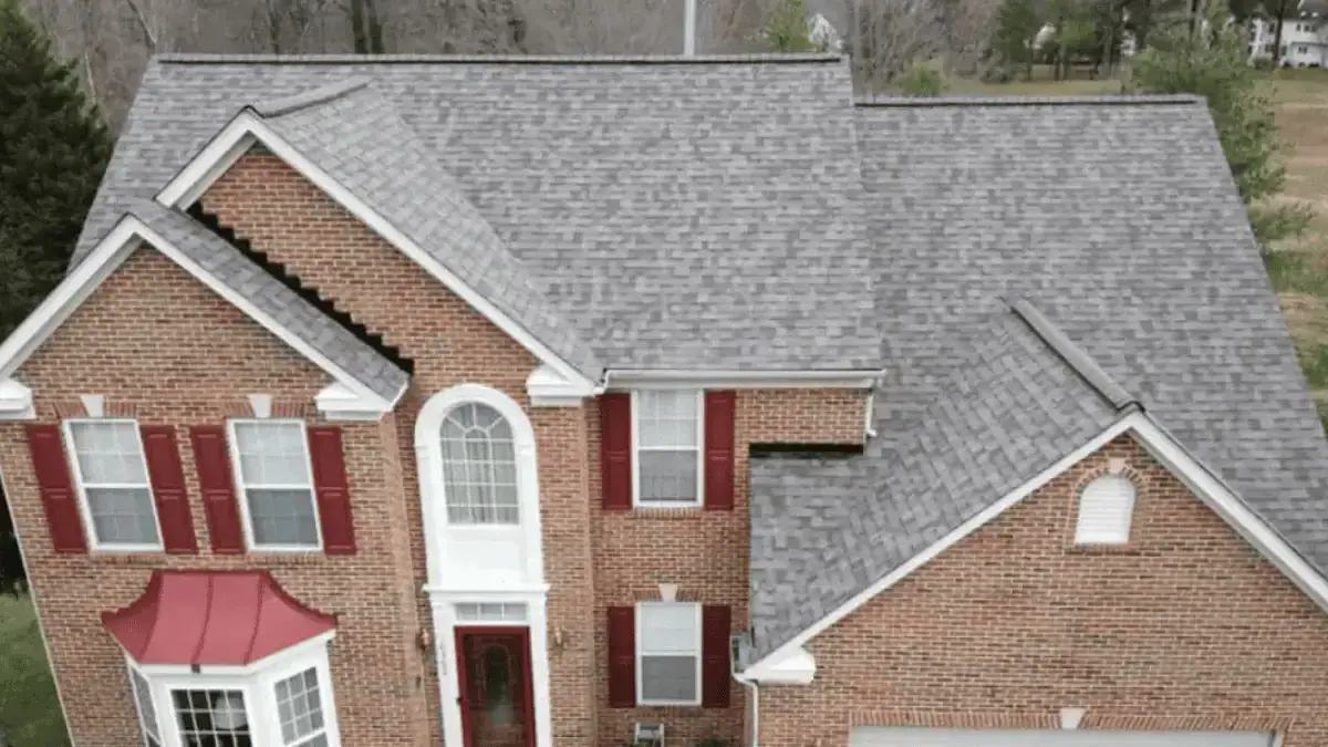 JDH Remodeling aerial brick colonial Hughesville Maryland home with multiple gables and a documented Owens Corning Duration architectural shingle replacement