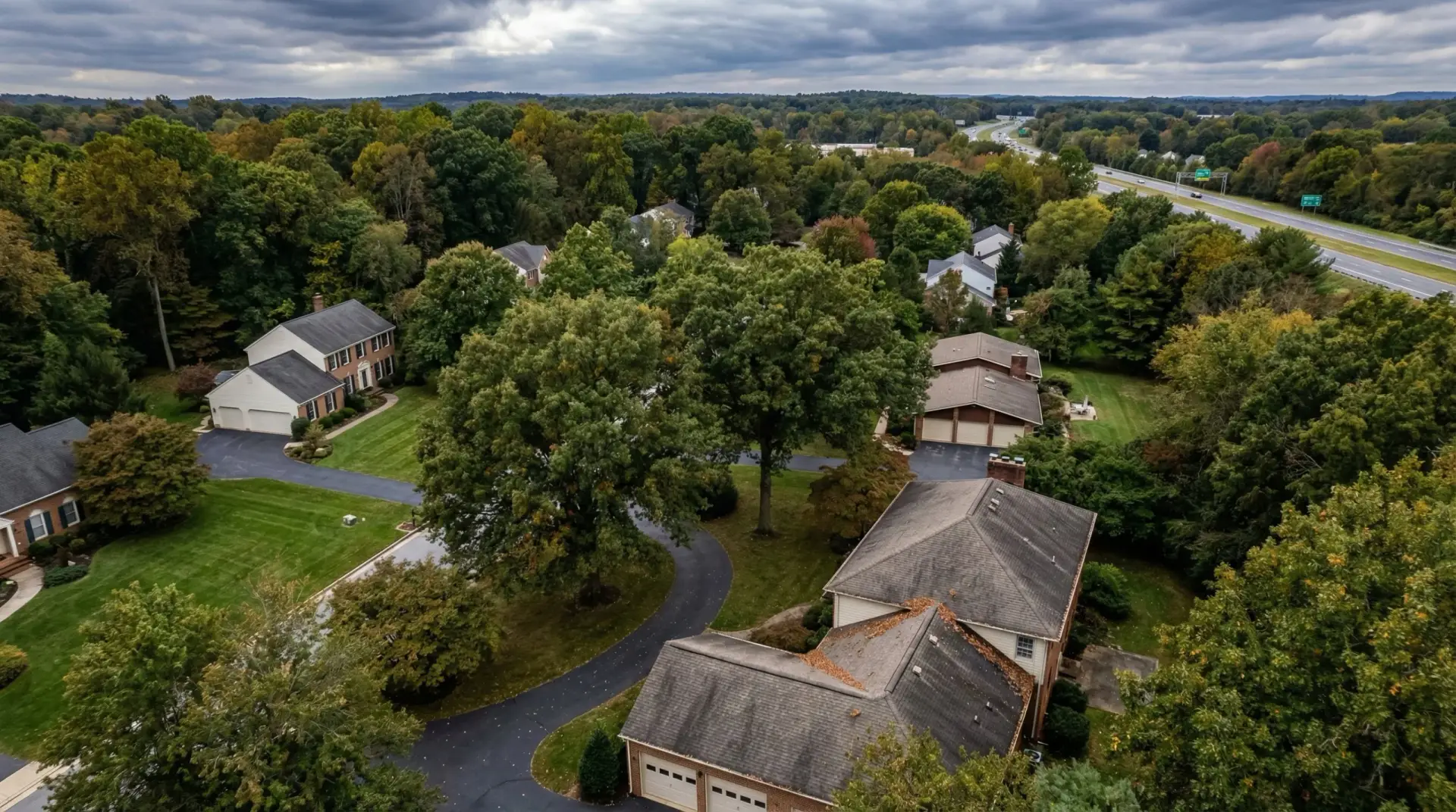 Aerial view of a Dunkirk Maryland residential home during active roof replacement with tear-off and new shingles in progress documented by JDH Remodeling