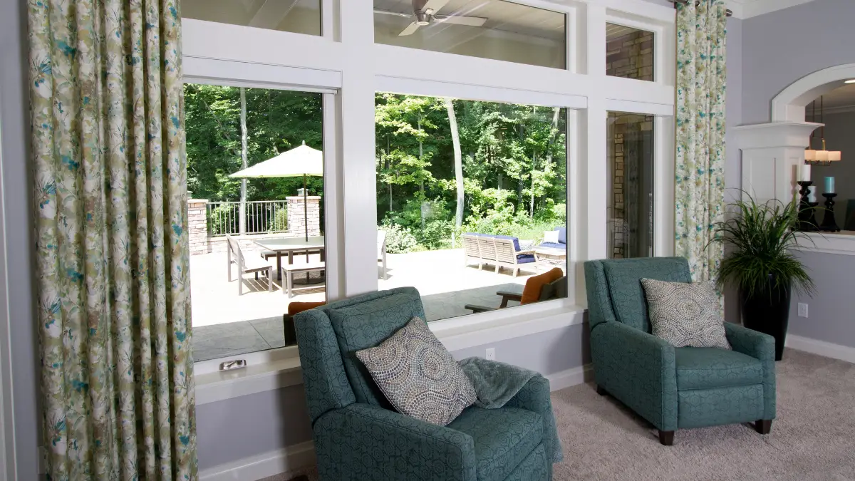 Bright interior with new ProVia sliding glass doors overlooking a manicured deck and wooded Maryland yard