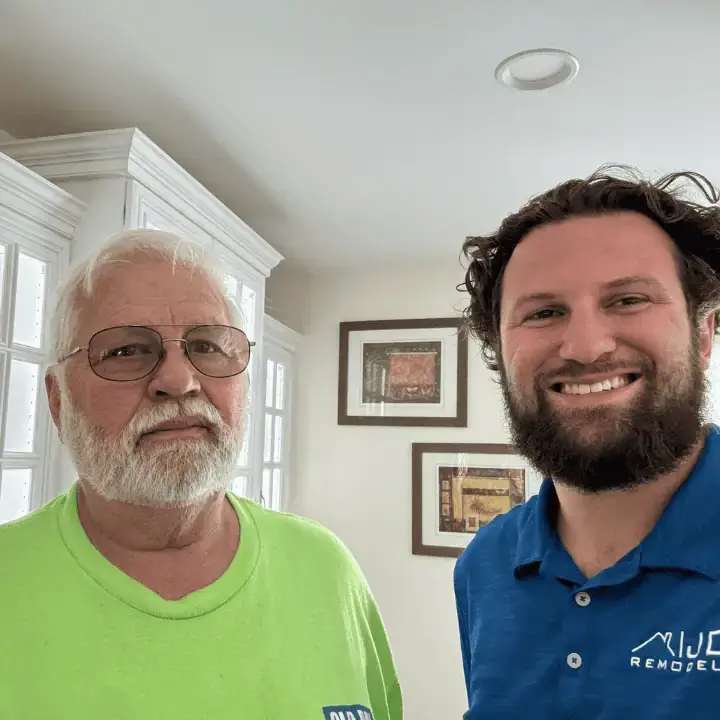 JDH Remodeling contractor shaking hands with satisfied homeowner after completing a roof repair at a Prince Frederick Maryland home