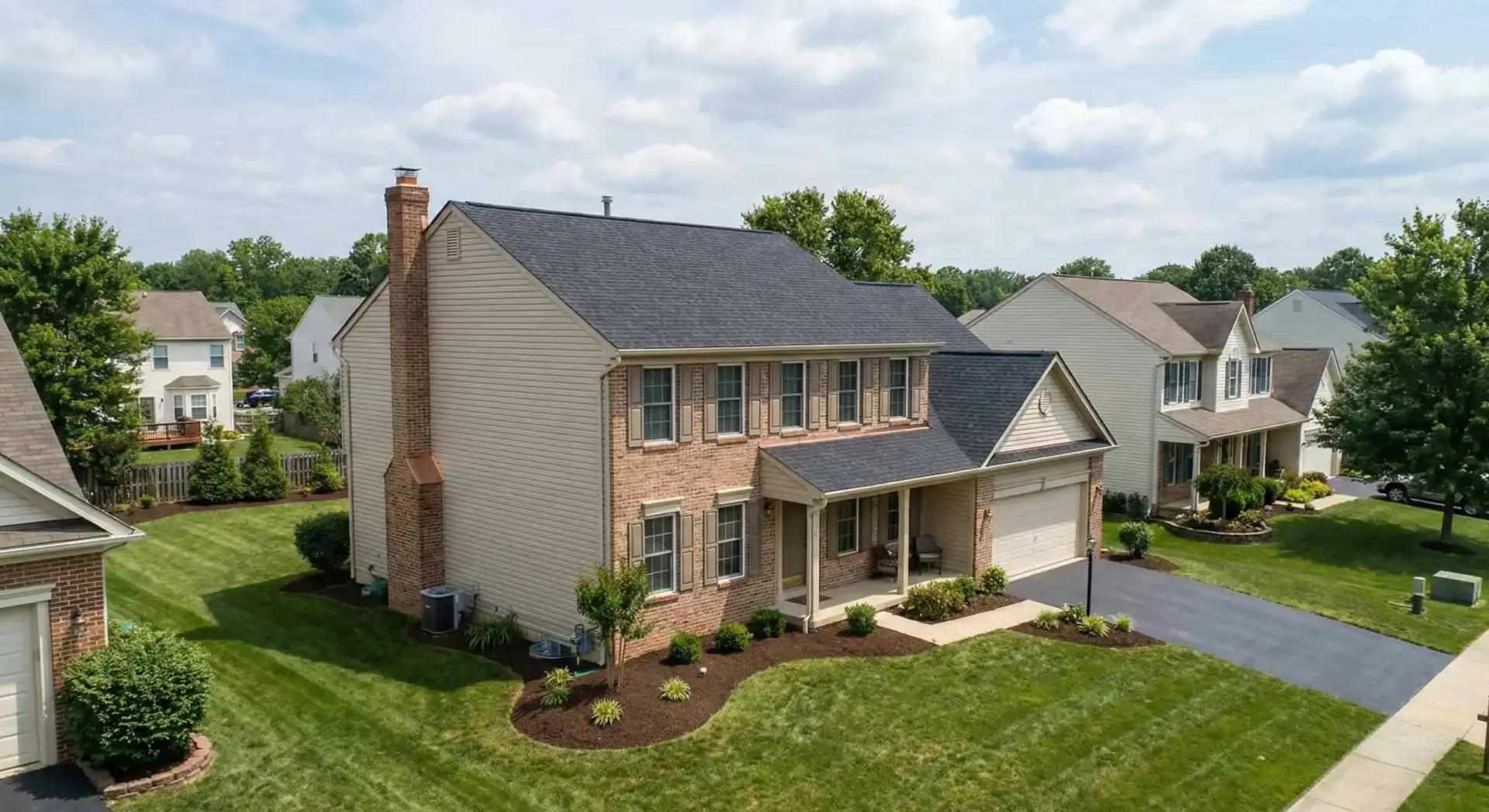 Completed Owens Corning Platinum roof replacement on a Waldorf Maryland St. Charles village colonial by JDH Remodeling, insurance-claim approved with siding refresh