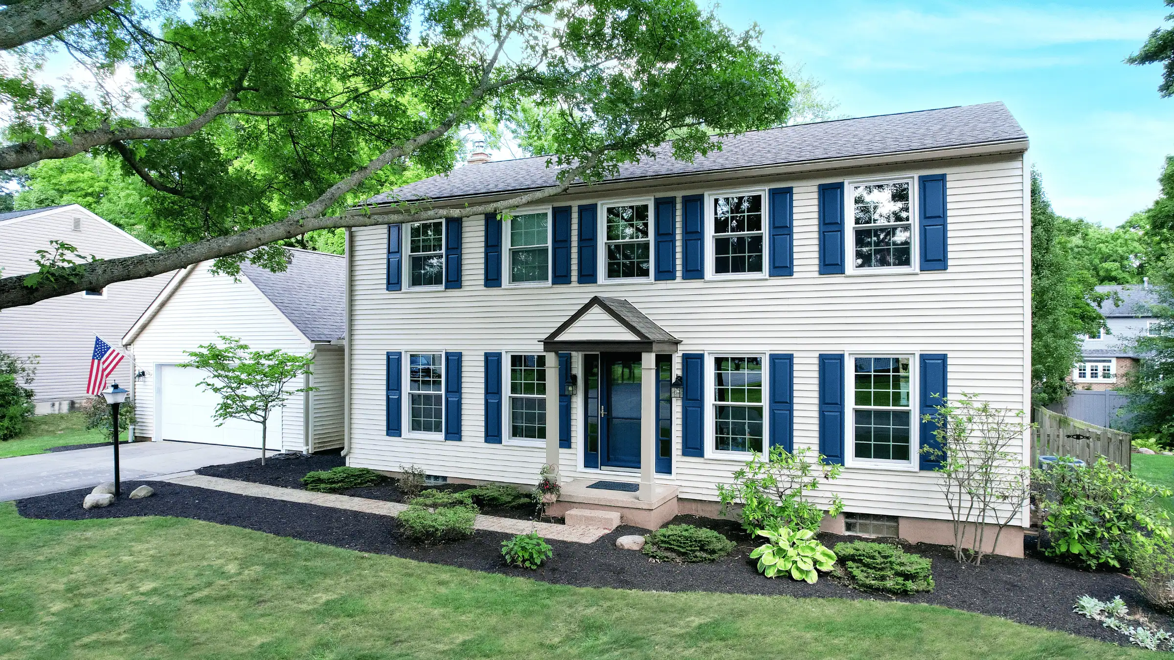 JDH Remodeling renovated two-story colonial Hughesville Maryland home with navy shutters and replacement windows documented during a forensic PCC inspection visit