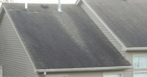 Asphalt shingle roof showing a noticeable sag in the deck, a serious structural issue caused by water damage or rot.